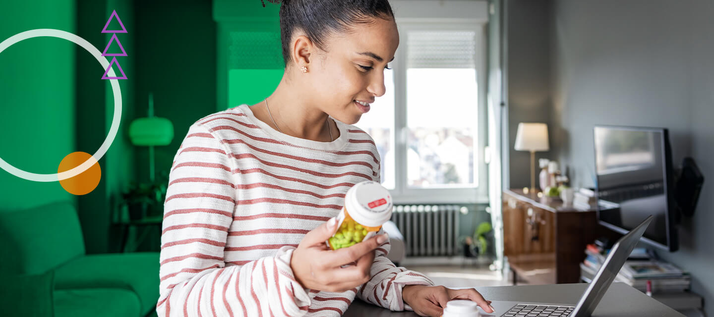 young woman checking prescription on laptop