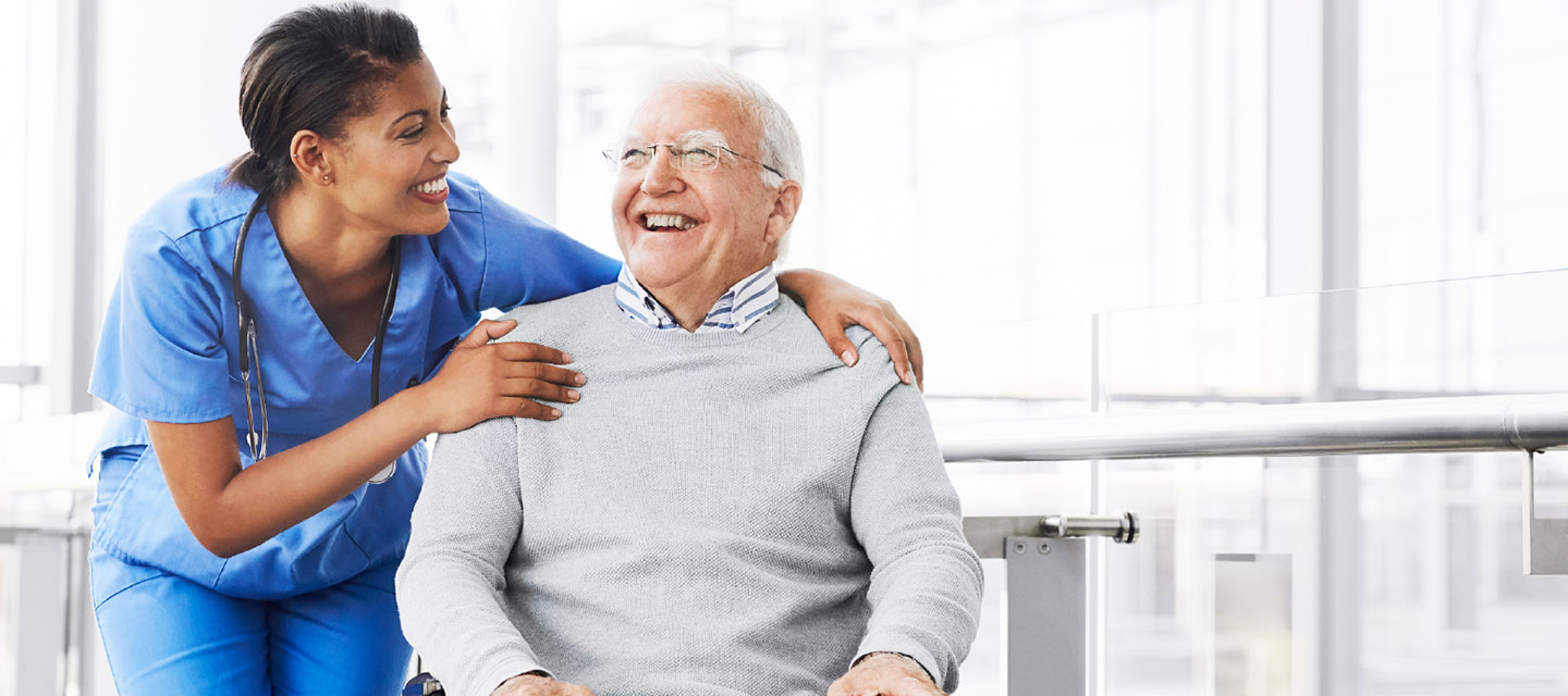 nurse laughing with older patient