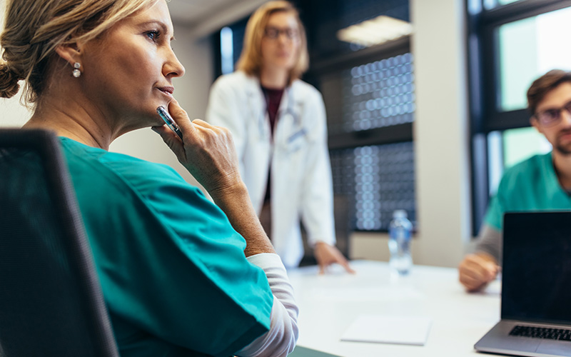 Female nurse in medical staff meeting