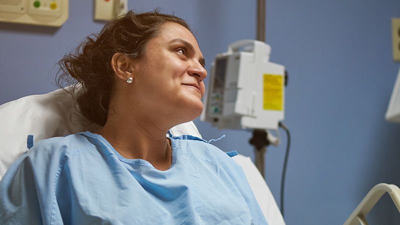 Woman in labor and delivery hospital bed