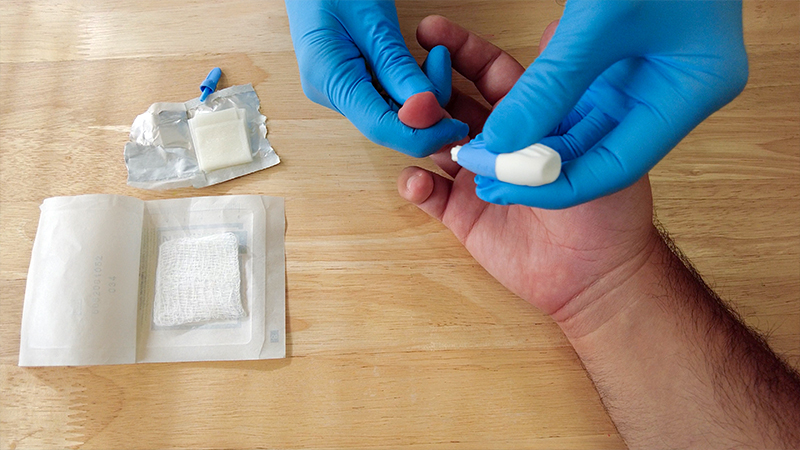 finger prick blood draw at a clinic