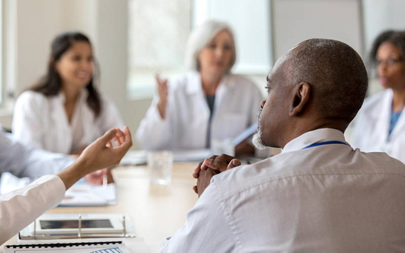 Hospital team discussing meeting topics