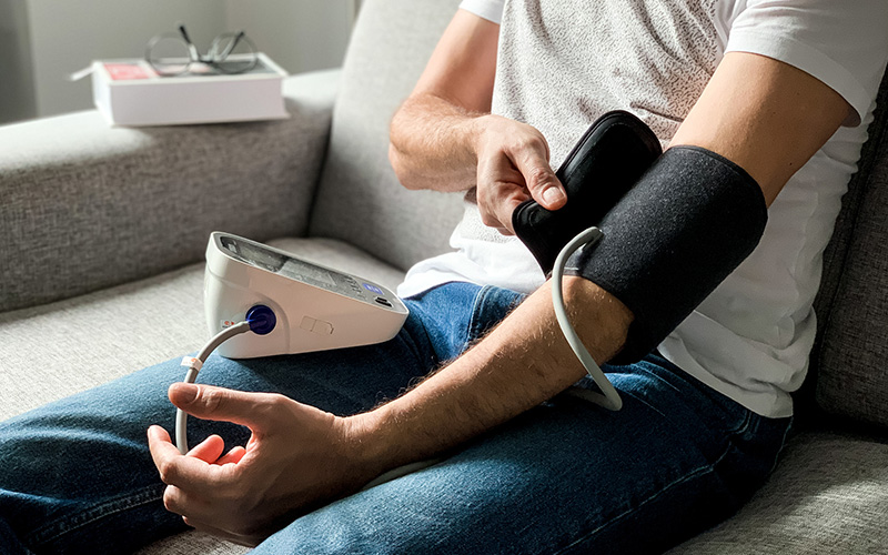 Man checking blood pressure at home