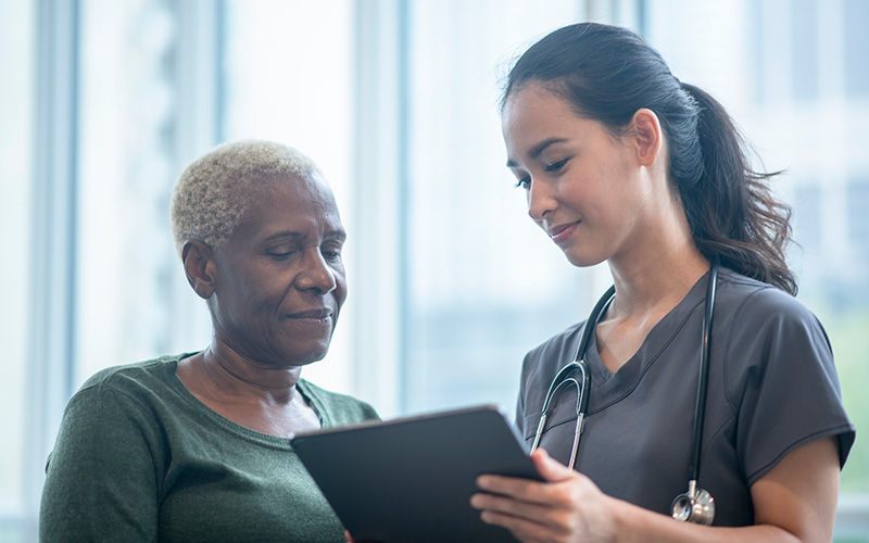 Medical professional reviewing questionnaire with patient 