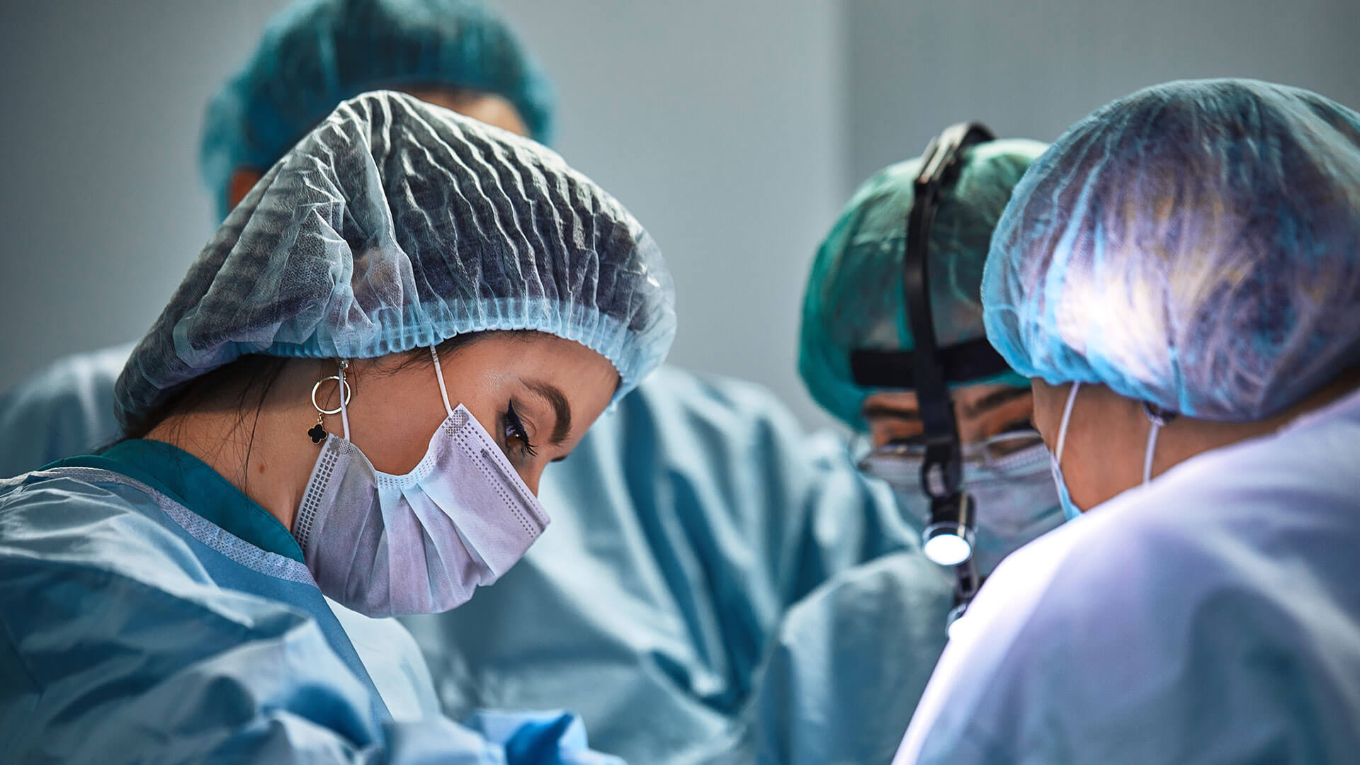 Surgeon and assistants in operating room