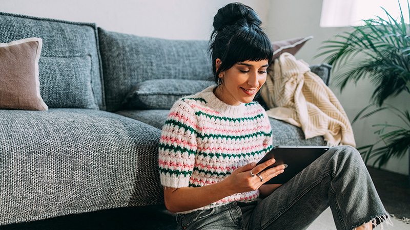 Young woman scheduling doctor visit on tablet