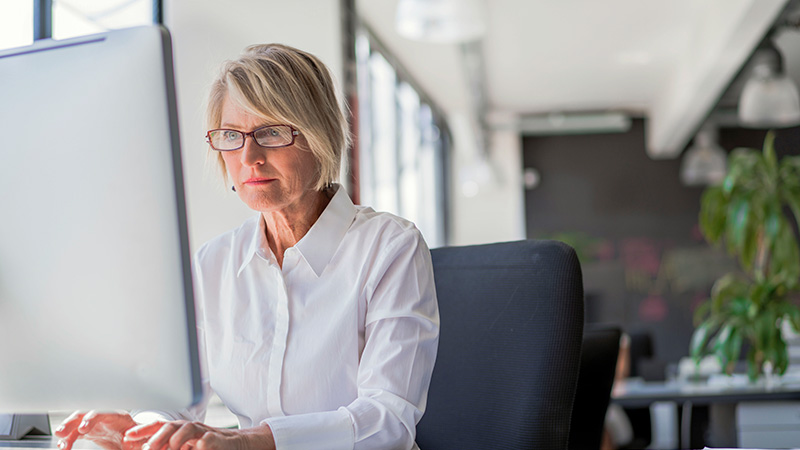 Businesswoman using computer at desk