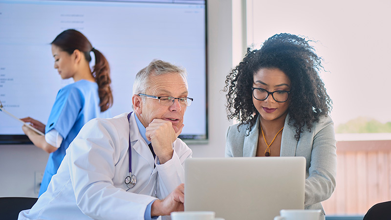 Doctor conversing with businesswoman