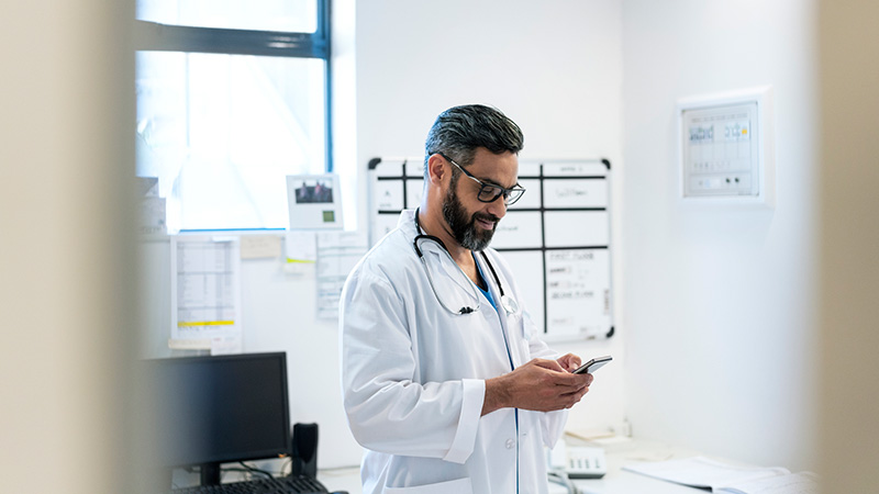 Doctor using phone in hospital office