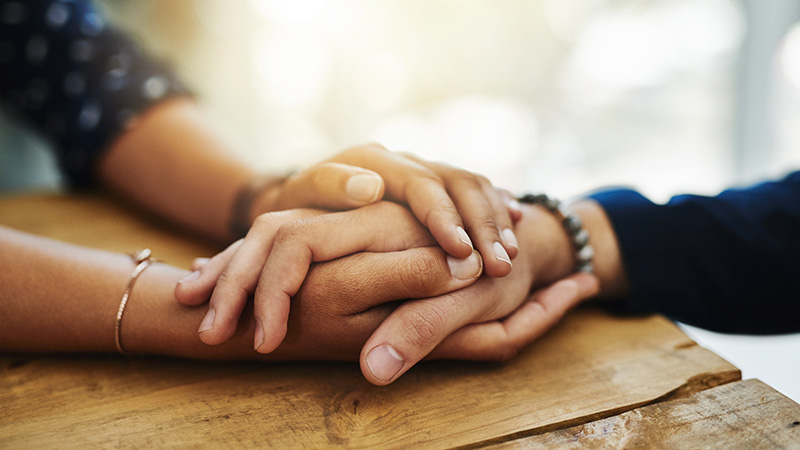 Two people holding hands