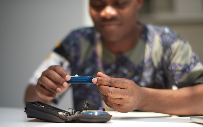 Young male taking blood sugar test