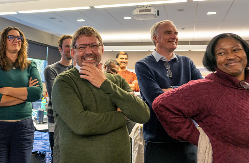 Group of Meditech employees standing together in conference room