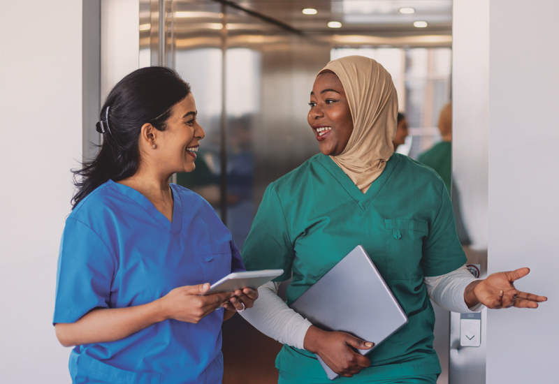 Two clinicians having a conversation while walking