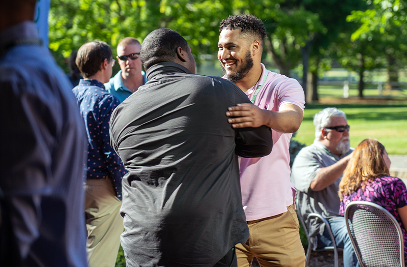 Two Meditech employees embracing each other