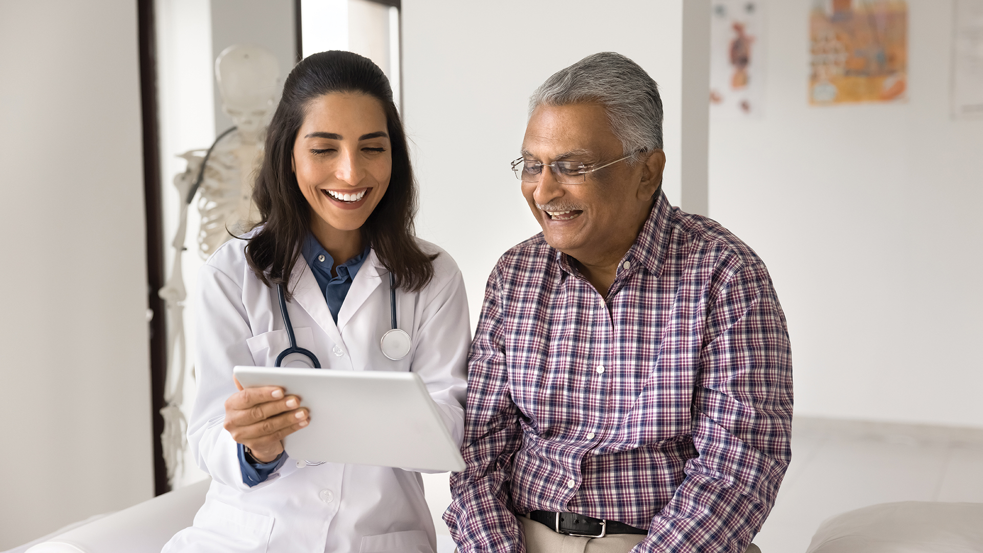 physician looking at an ipad with patient