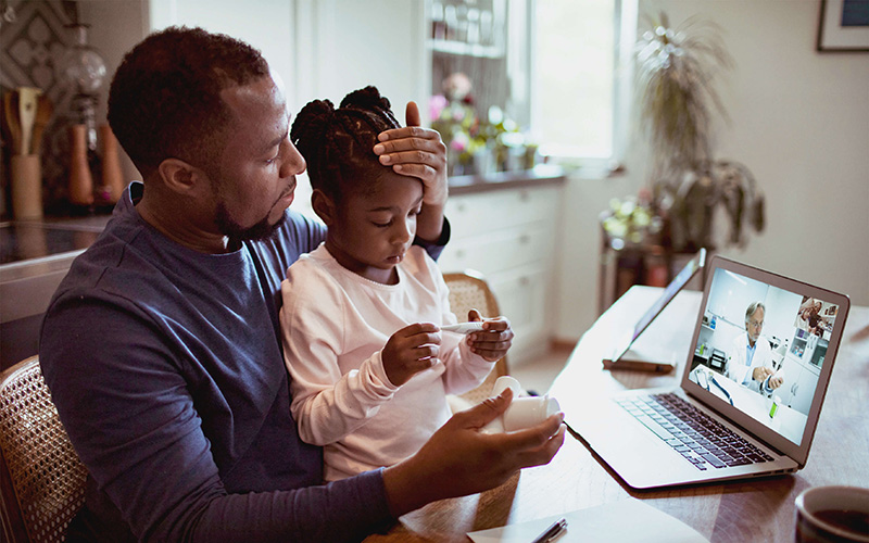 Man using virtual care to diagnose daughter