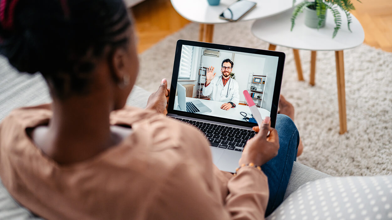 Young Pregnant Woman Having A Doctors Appointment On A Laptop