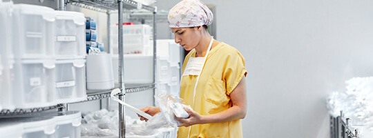 Surgeon picking medical supplies in storage room