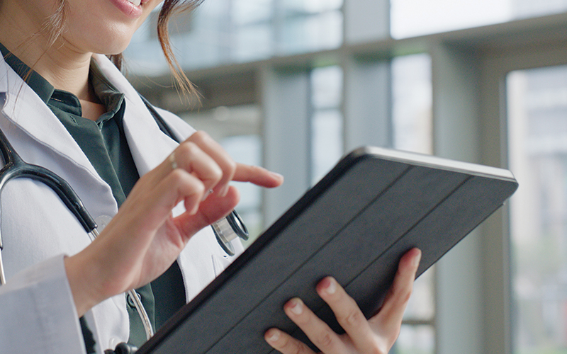 clinician holding tablet with
