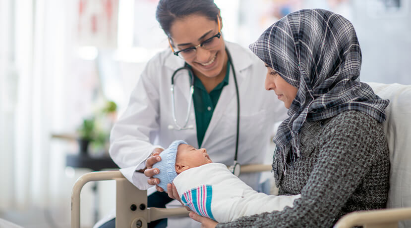 Doctor checking on newborn and mother