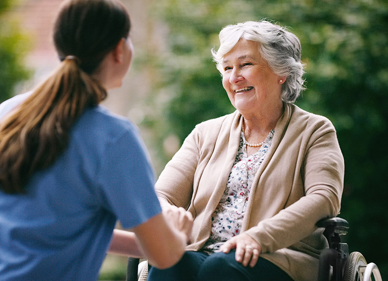 Female nurse assisting elderly patient