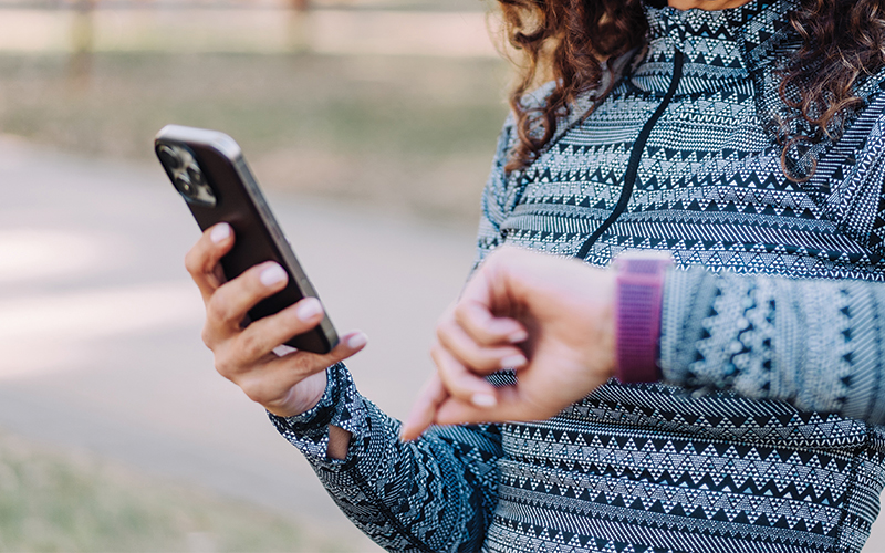 patient accessing health data on their phone and smart watch