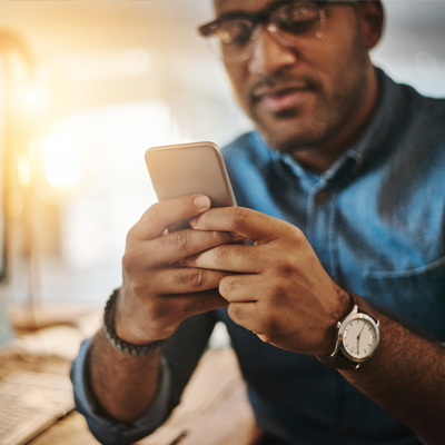 Man using iphone at desk