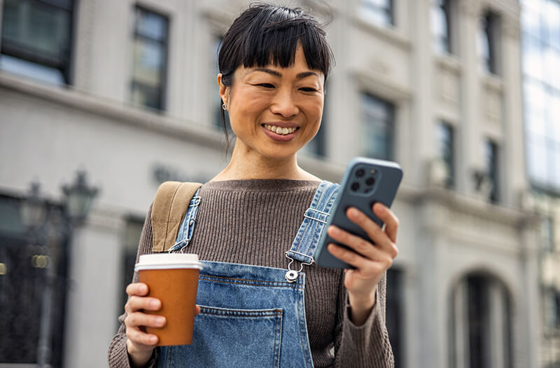 middle aged woman checking phone on the go