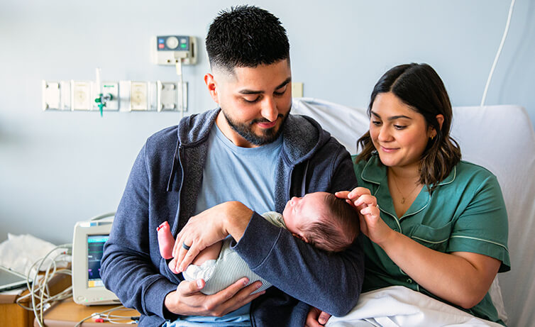 Parents with their newborn in a hospital room