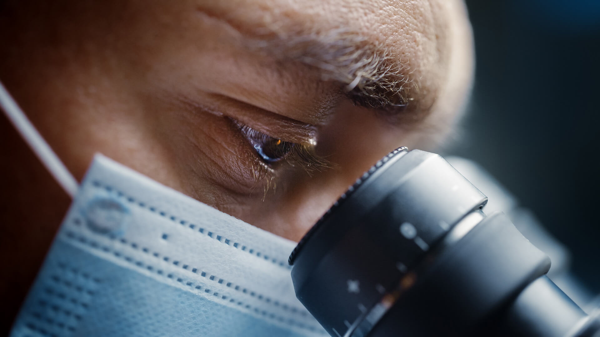 Pathologist looking through microscope