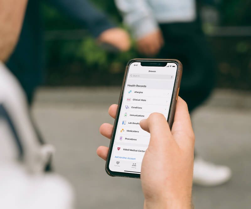 Person checking their health records on an iPhone