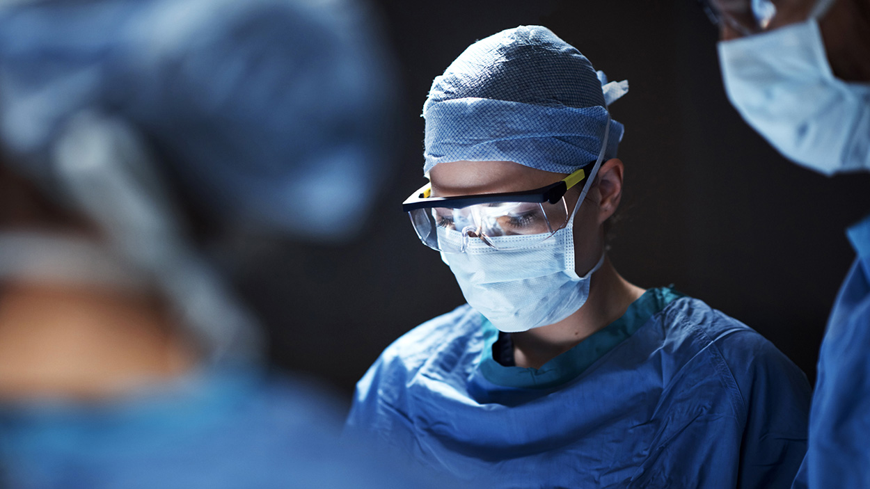 Physician tying mask in preperation of surgery