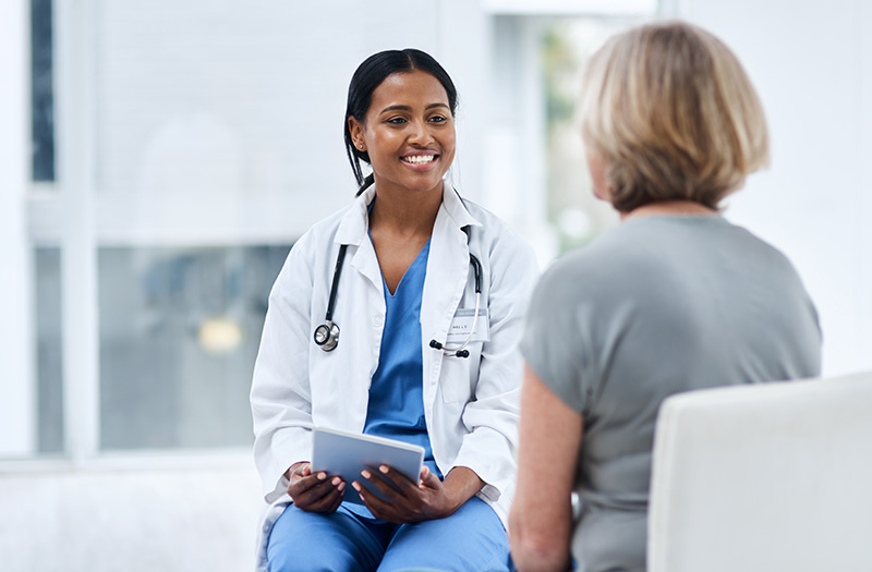 Physician talking with patient while using EHR