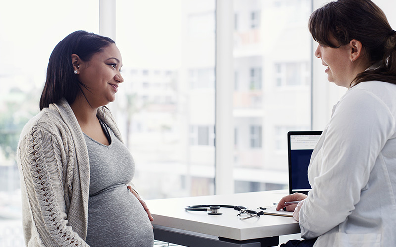 Pregnant woman having consultation with doctor