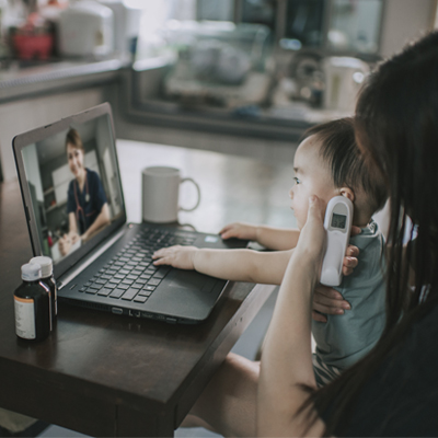 woman taking child's temp over virtual visit