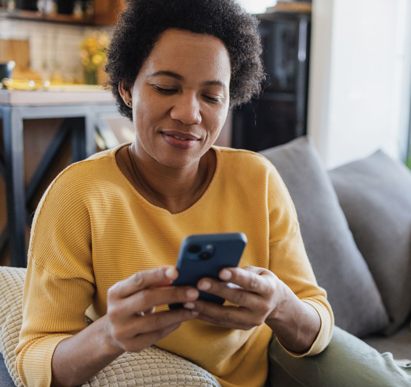 ethnic-woman-using-smart-phone-for-pre-check-in