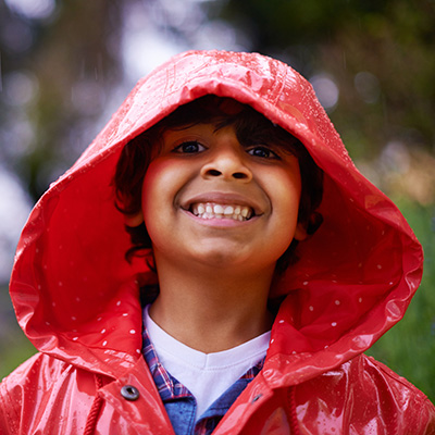 David's head shot - young boy smiling in the rain