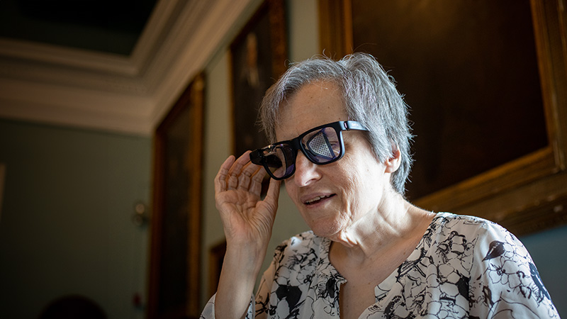 Elderly woman with vision disability using glasses